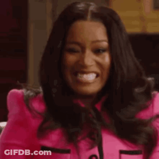 A Woman In A Pink Jacket Is Making A Funny Face And Looking At The Camera . GIF