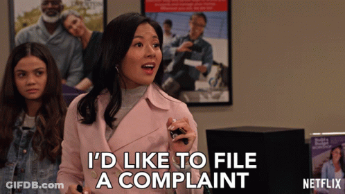 A Woman In A Pink Jacket Says " I 'D Like To File A Complaint " GIF