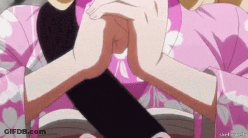 A Woman In A Pink Kimono Is Holding A Black Object Between Her Hands . GIF