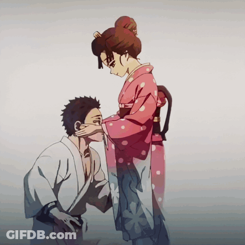 A Woman In A Pink Polka Dot Kimono Is Touching The Face Of A Man GIF