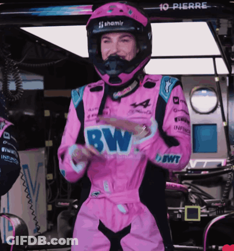 A Woman In A Pink Racing Suit With Bw Written On The Front GIF