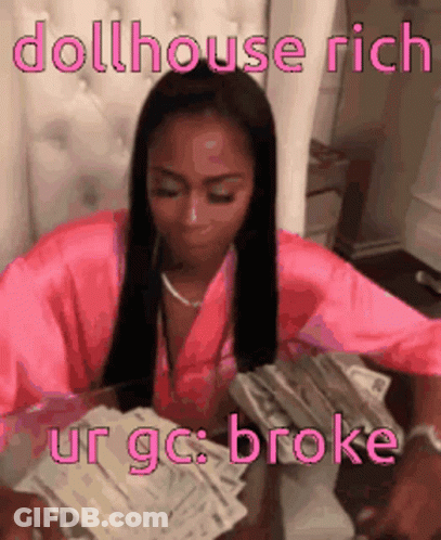 A Woman In A Pink Robe Is Sitting At A Table With A Stack Of Money . GIF