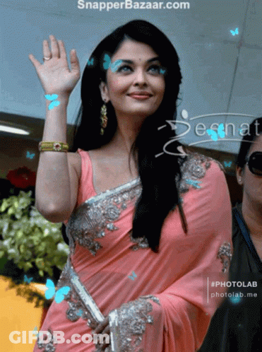 A Woman In A Pink Saree Is Being Photographed By Snapper Bazaar GIF