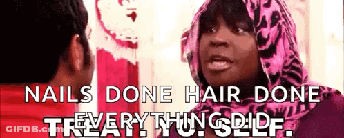 A Woman In A Pink Scarf Is Talking To A Man With The Words " Nails Done Hair Done " On The Bottom GIF