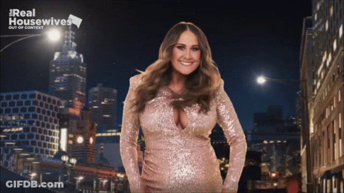A Woman In A Pink Sequined Dress Is Standing In Front Of A Real Housewives Logo GIF