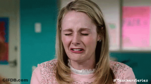 A Woman In A Pink Shirt Is Crying And Making A Funny Face With Her Eyes Closed . GIF