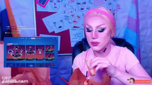 A Woman In A Pink Shirt Is Eating A Chicken Nugget While Watching A Video GIF