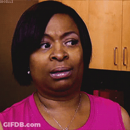 A Woman In A Pink Shirt Is Making A Face GIF