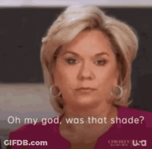 A Woman In A Pink Shirt Is Making A Funny Face And Says `` Oh My God , Was That Shade ? '' GIF