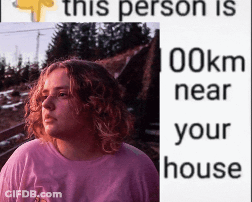 A Woman In A Pink Shirt Is Next To A Sign That Says This Person Is 100Km Near Your House GIF