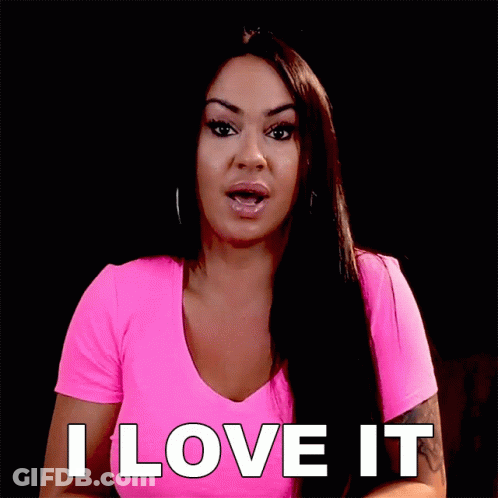 A Woman In A Pink Shirt Is Saying " I Love It " GIF