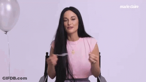A Woman In A Pink Shirt Is Sitting In A Chair And Says `` I Know Because '' . GIF