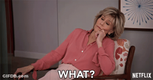 A Woman In A Pink Shirt Is Sitting In A Chair With The Words What On The Bottom GIF