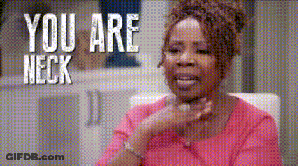 A Woman In A Pink Shirt Is Sitting In A Chair With The Words `` You Are Neck '' Behind Her . GIF