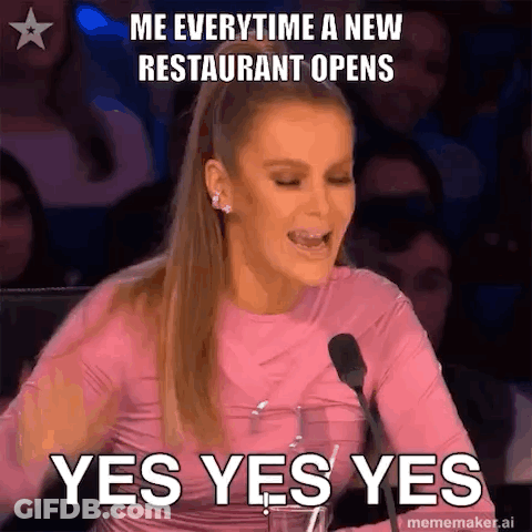 A Woman In A Pink Shirt Is Sitting In Front Of A Microphone And Making A Funny Face . GIF