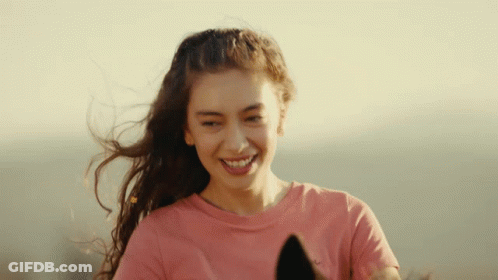 A Woman In A Pink Shirt Is Smiling And Holding A Horse GIF