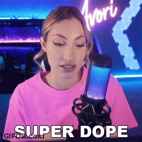A Woman In A Pink Shirt Is Talking Into A Microphone And Saying Super Dope GIF