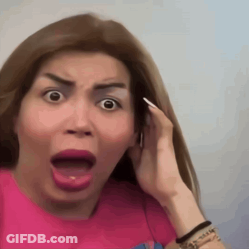 A Woman In A Pink Shirt Making A Surprised Face GIF