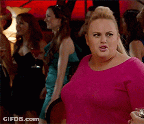 A Woman In A Pink Shirt Stands In A Crowd Of Women GIF