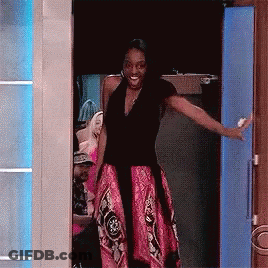 Woman In Pink Skirt Standing In Doorway GIF
