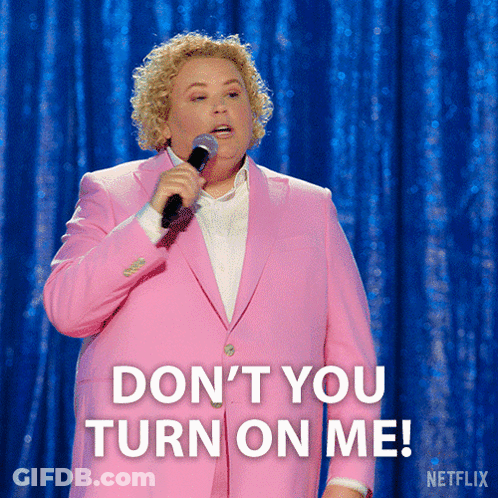 A Woman In A Pink Suit Is Holding A Microphone And Saying " Don 'T You Turn On Me " GIF