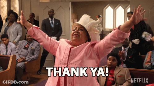 A Woman In A Pink Suit Says Thank Ya In Front Of A Netflix Logo GIF
