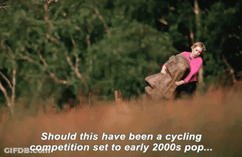 Woman In Pink Sweater Holding Large Rock GIF