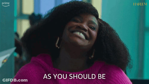 A Woman In A Pink Sweater Is Smiling And Says As You Should Be GIF