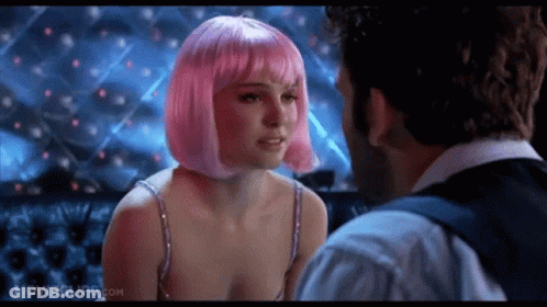 A Woman In A Pink Wig Is Kissing A Man In A Movie . GIF