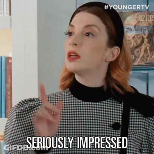 A Woman In A Plaid Dress Is Making A Gesture And Says Seriously Impressed GIF
