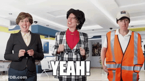 A Woman In A Plaid Jacket Is Standing Next To A Man In An Orange Vest Who Says Yeah GIF