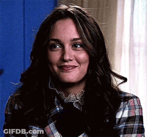 A Woman In A Plaid Shirt And Tie Is Smiling . GIF