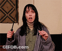 A Woman In A Plaid Shirt Is Holding A Knife GIF