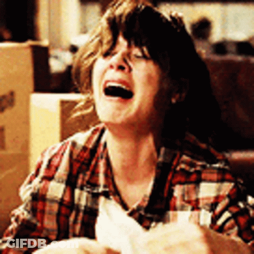 A Woman In A Plaid Shirt Is Laughing GIF
