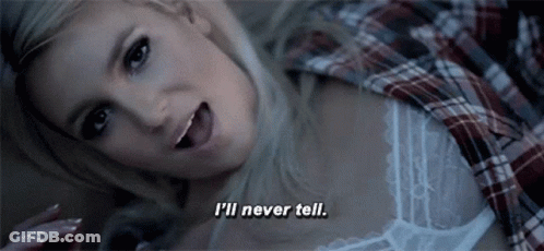 A Woman In A Plaid Shirt Is Laying Down And Says I 'Ll Never Tell GIF
