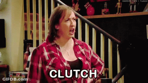 A Woman In A Plaid Shirt Is Screaming And Saying Clutch While Standing On A Set Of Stairs . GIF