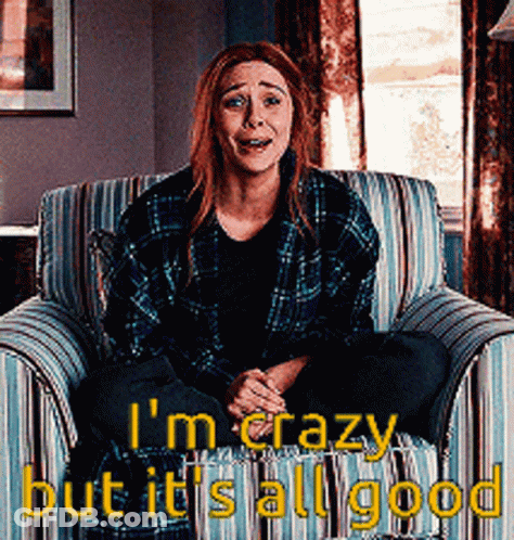 A Woman In A Plaid Shirt Is Sitting In A Chair With The Words " I 'M Crazy But It 'S All Good " GIF