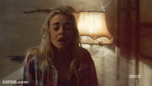 A Woman In A Plaid Shirt Is Standing In Front Of A Lamp With The Word Starz On The Bottom GIF