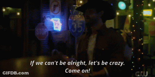 A Woman In A Plaid Shirt Stands In Front Of A Bar With A Neon Sign That Says Beer GIF