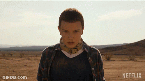 A Woman In A Plaid Shirt Stands In The Desert With Netflix Written On The Bottom GIF