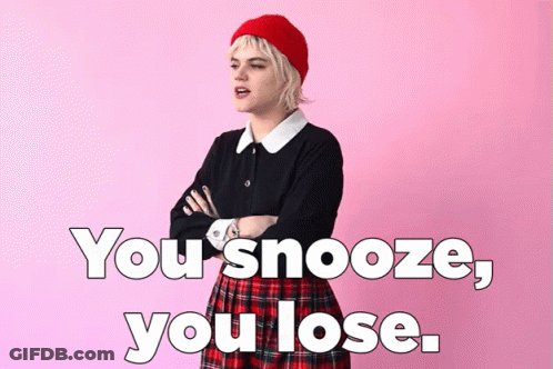 A Woman In A Plaid Skirt Is Standing With Her Arms Crossed In Front Of A Pink Background With The Words You Snooze You L GIF