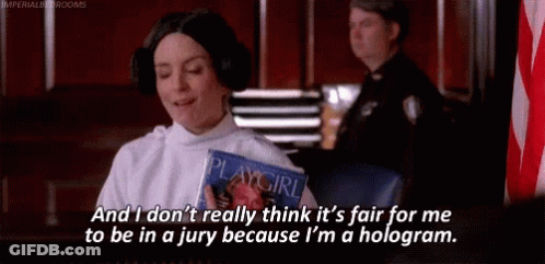 A Woman In A Playgirl Costume Is Sitting In A Courtroom Holding A Playgirl Magazine . GIF