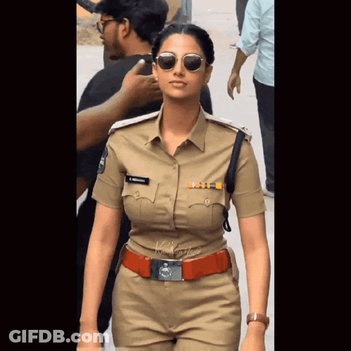 A Woman In A Police Uniform Has A Name Tag On Her Chest That Says ' S. Krishna ' GIF