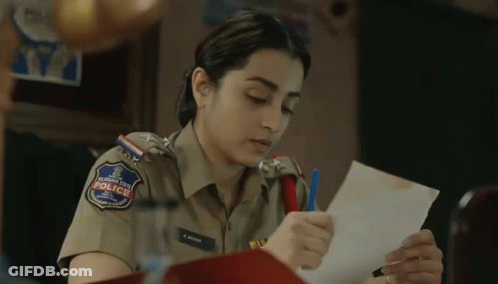 A Woman In A Police Uniform Is Holding A Piece Of Paper In Her Hand . GIF