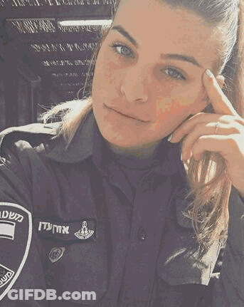 A Woman In A Police Uniform Is Looking At The Camera With Her Hand On Her Forehead . GIF