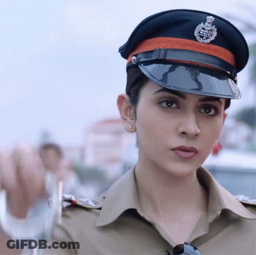 A Woman In A Police Uniform With A Badge That Says ' Delhi ' On It GIF