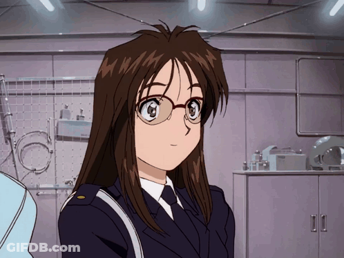 A Woman In A Police Uniform With Glasses Stands In Front Of A Shelf That Says Bosch GIF