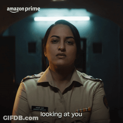 A Woman In A Police Uniform With The Words Amazon Prime Looking At You GIF