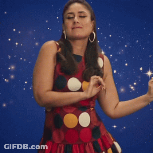 A Woman In A Polka Dot Dress Is Dancing GIF