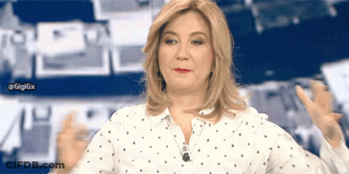 A Woman In A Polka Dot Shirt Is Giving A Thumbs Up Sign GIF